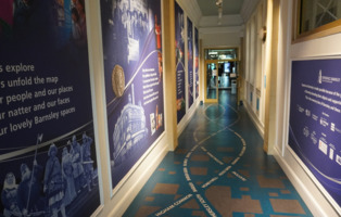 Corridor leading down Experience Barnsley Museum showing the main gallery in the background.